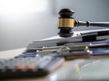 Judge and documents on office desk Legislation Versicherungsmakler Essen