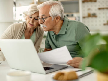 Senior couple analyzing their savings while going through home f Versicherungsmakler Essen